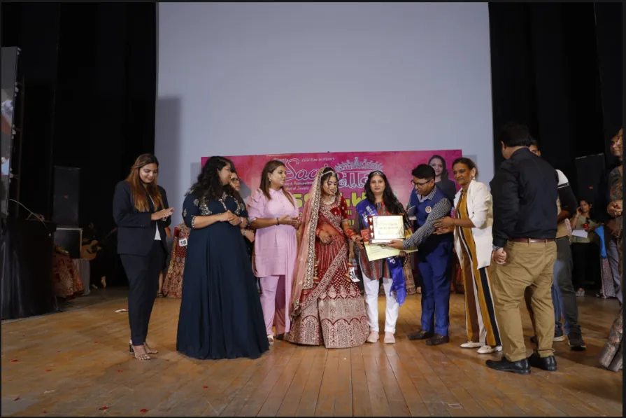 Bimla receiving recognition at the makeup competition award ceremony in Alwar